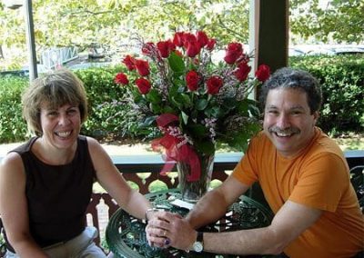 Guest Photos- Happy couple next to roses in vase at Queen Victoria