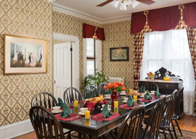 Prince Albert Hall Dining Room. Places set with Orange Juice and a Basket of Muffins